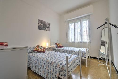 een slaapkamer met 2 bedden en een raam bij Mariani's Home in Finale Ligure