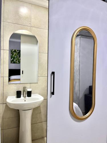 a bathroom with a sink and a mirror at Ivywood loft @ Monarch Studios in Polokwane