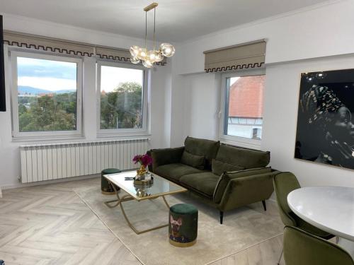 a living room with a couch and a table at Elite Apartment in Sibiu