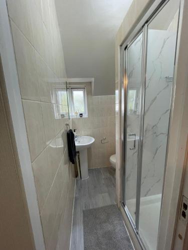 a bathroom with a shower and a sink at London Guest Studios 8 in London