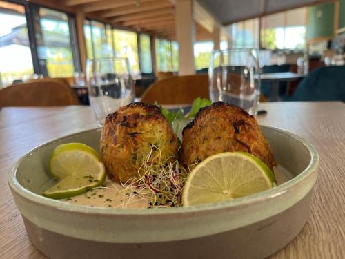 a bowl of food with chickens and lemons on a table at Domaine Les Nids du Lac in Sanchey