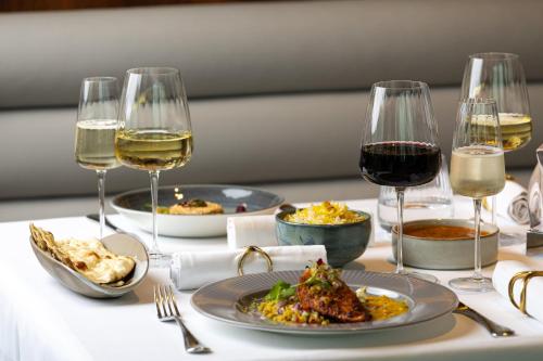 a table with plates of food and glasses of wine at InterContinental London - The O2 in London