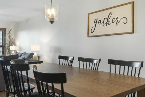 a dining room with a wooden table and black chairs at Table Rock Resorts at Indian Point in Branson