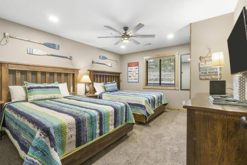 a bedroom with two beds and a ceiling fan at Table Rock Resorts at Indian Point in Branson