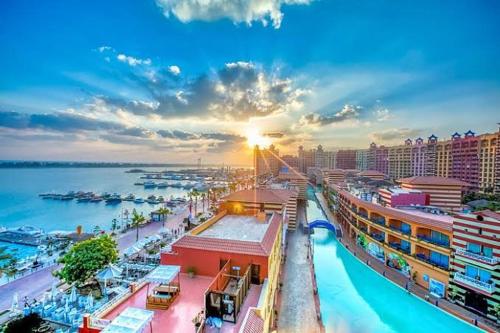 a view of a city with the ocean and buildings at PORTO MARINA TOWERS SEA & POOL VIEW North Coast in El Alamein