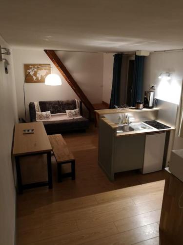 a kitchen with a sink and a table in a room at Hypercentre résidence paisible in Fontainebleau