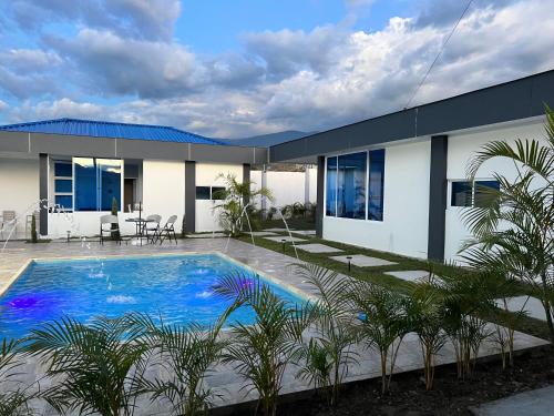 a house with a swimming pool in front of it at Cabañas Compostela gigante in Gigante