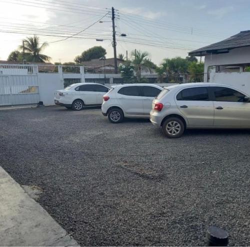 a group of three cars parked in a parking lot at Nômade no Liberdade in Boa Vista