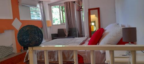 a room with a bed and a table and a mirror at Maison in Chevalier