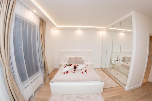 a white room with a bed and a mirror at SINFONIA LUX in Belgrade