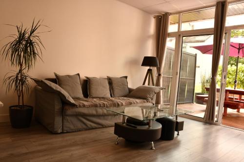 a living room with a couch and a glass table at kerloch gwen in Combrit