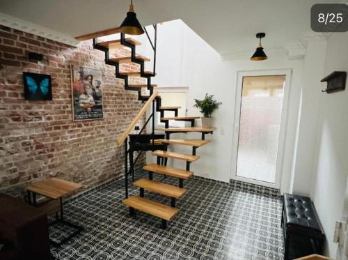 a spiral staircase in a room with a brick wall at See Schmetterling (Fjäril) in Wismar