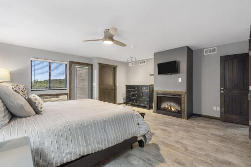 a bedroom with a bed with a fireplace and a tv at Table Rock Resorts at Indian Point in Branson
