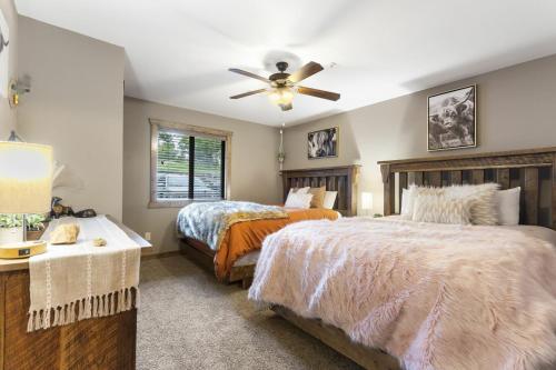 a bedroom with two beds and a ceiling fan at Table Rock Resorts at Indian Point in Branson