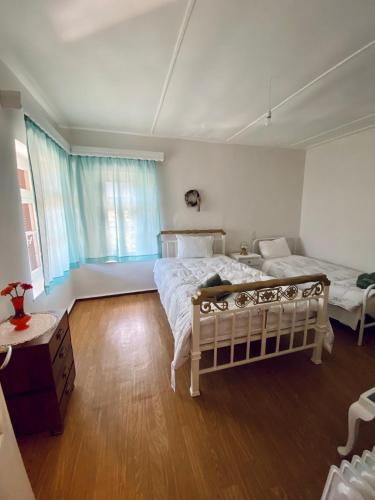 A bed or beds in a room at Pavlianis Cottage House