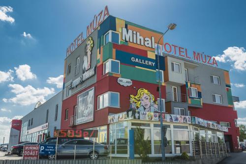 a building with a sign on the side of it at Hotel Muza in Košice