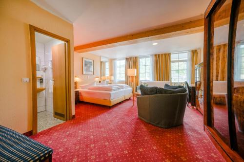 a hotel room with a bed and a couch at Hotel Rheinfels in Sankt Goar