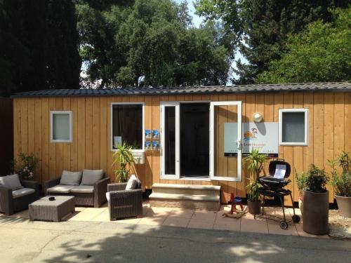 a small shed with a couch and a chair at Vic's Land Holidays in Grimaud