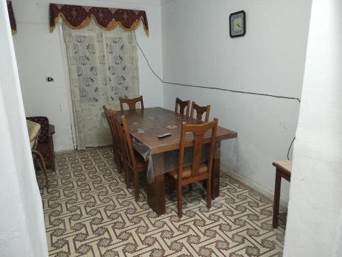 a dining room table and chairs in a room at Agami Guest House in Alexandria