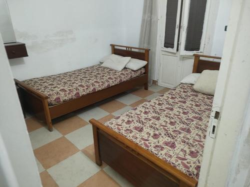 two beds sitting in a room with at Agami Guest House in Alexandria