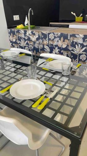 a glass counter top with plates and utensils on it at Vistas al campo in Camarma de Esteruelas