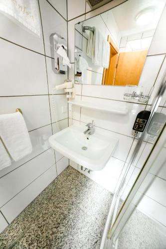 a bathroom with a sink and a mirror at Hotel Rheinfels in Sankt Goar