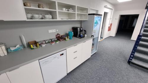 a kitchen with white cabinets and a refrigerator at Ubytování na letišti Ostrava Mošnov in Mošnov