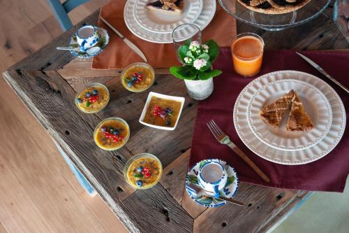 a wooden table with plates of food on it at Agriturismo Borgo Malva' in San Venanzo