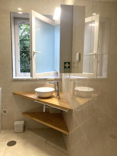 a bathroom with a sink and a mirror at Casa Ar da Beira - Serra da Estrela - Belmonte in Belmonte
