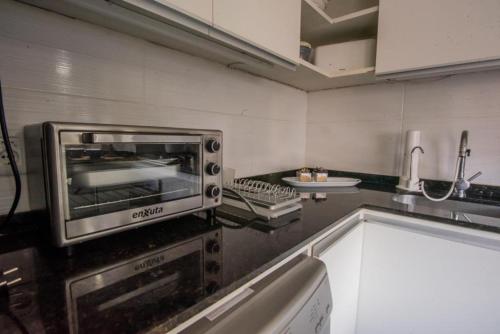 a kitchen with a toaster oven on a counter at Exclusivo Apto Calle Principal in Salto