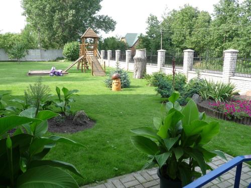 a yard with a playground with a play equipment at Skaistažiedė in Šiauliai