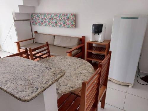 Una sala de estar con una mesa y sillas y un sofá. en Casa 22B, MONT HEBROM, en Porto Seguro