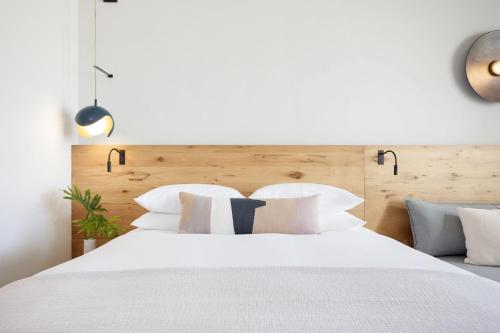 a bedroom with a large white bed with white pillows at Hotel Indigo Grand Cayman by IHG in Grand Cayman