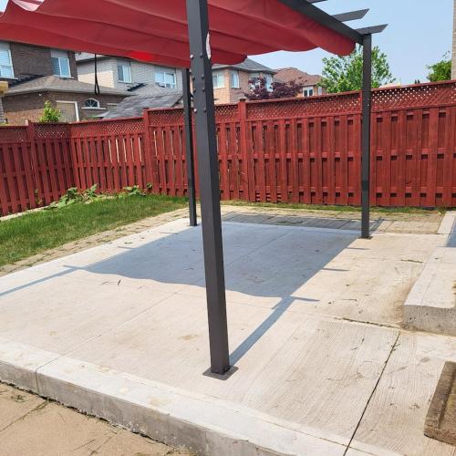 a pole on a sidewalk with a red fence at Luxury Home in Mississauga in Mississauga