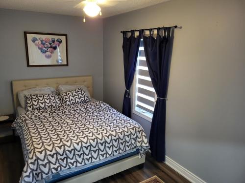 a bedroom with a bed and a window at Luxury Home in Mississauga in Mississauga