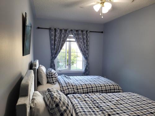 a bedroom with two beds and a window at Luxury Home in Mississauga in Mississauga