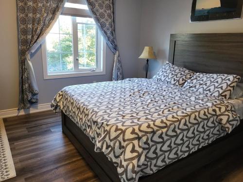 a bedroom with a bed and a window at Luxury Home in Mississauga in Mississauga
