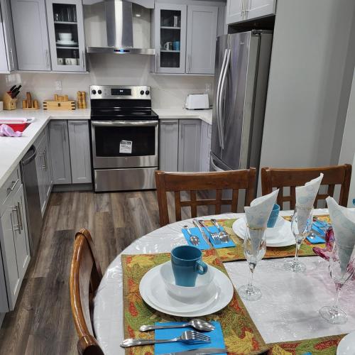 a kitchen with a table and chairs and a kitchen with at Luxury Home in Mississauga in Mississauga