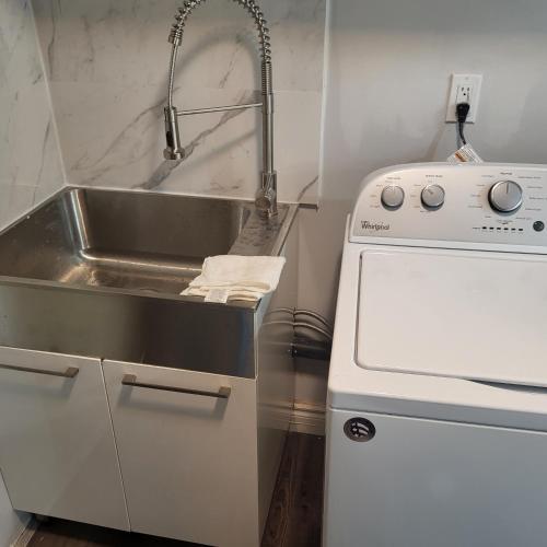 a small kitchen with a sink and a sinkiterator at Luxury Home in Mississauga in Mississauga