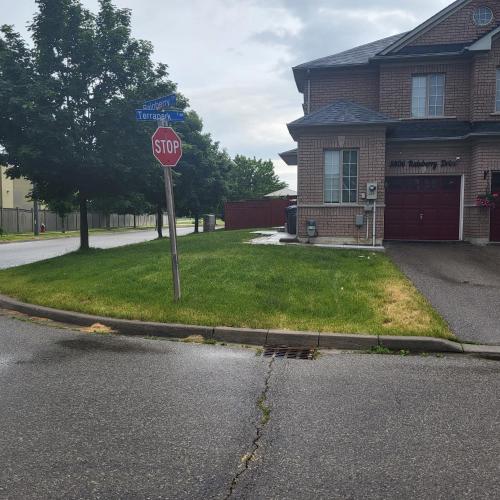 a stop sign in front of a house at Luxury Home in Mississauga in Mississauga