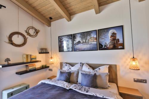 a bedroom with a bed and pictures on the wall at Relax V Kraji in Žernov