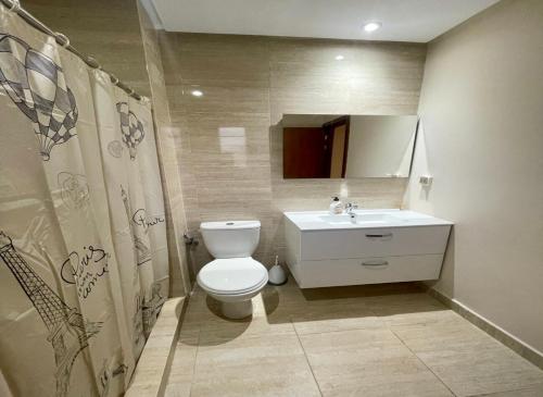 a bathroom with a white toilet and a sink at Condo à Prestigia Agate - Golf city Marrakech in Marrakech