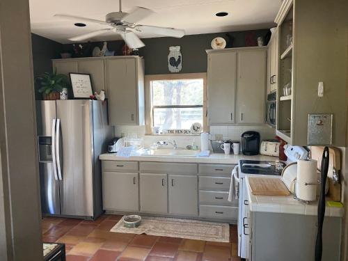 a kitchen with a refrigerator and a sink at Around the Bend Bungalow in Fredericksburg