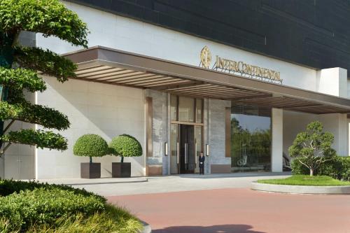 a man standing in front of a building at InterContinental Hotels Zhengzhou in Zhengzhou