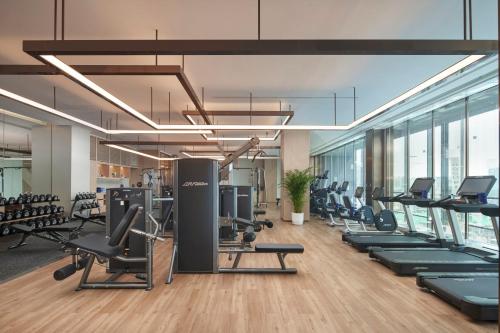 a gym with a lot of treadmills and exercise equipment at InterContinental Hotels Zhengzhou in Zhengzhou