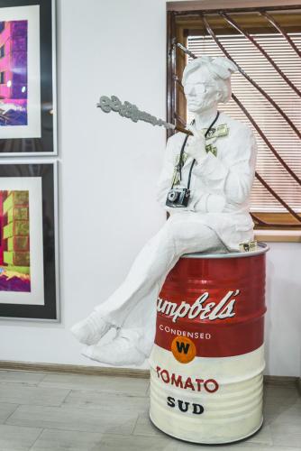 a statue of a man sitting on a barrel at Hotel Muza in Košice