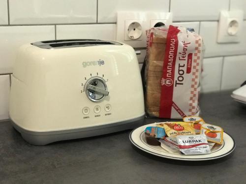 a toaster and a plate of food on a counter at Katoi House - Central Skyros Village in Skiros