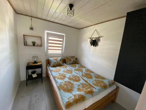 a bedroom with a bed in a room with a window at Bieszczadzka SielAnka in Ustrzyki Dolne