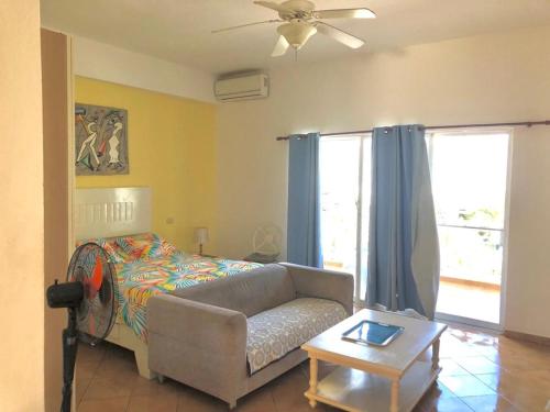 a living room with a couch and a bed at El Dorado Condo 208A in Punta Cana