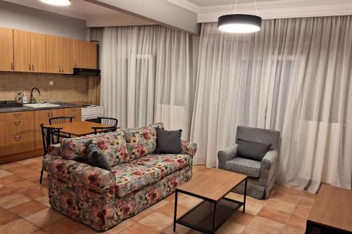 a living room with a couch and a table and a kitchen at Konstantinos in Thessaloniki